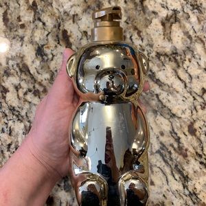 Golden teddy bear soap dispenser.